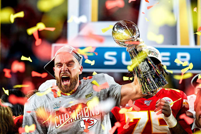 Travis Kelce celebrates with the Lombardi Trophy after Super Bowl LIV